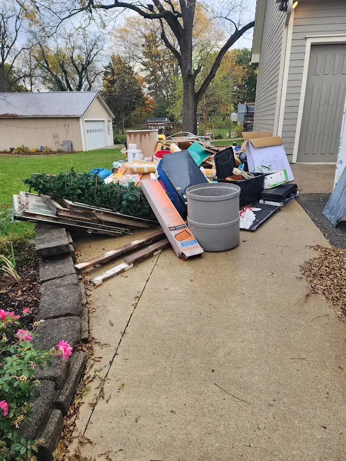 Dumpster being loaded with debris for 3 Yard Dumpster Rental in Plymouth